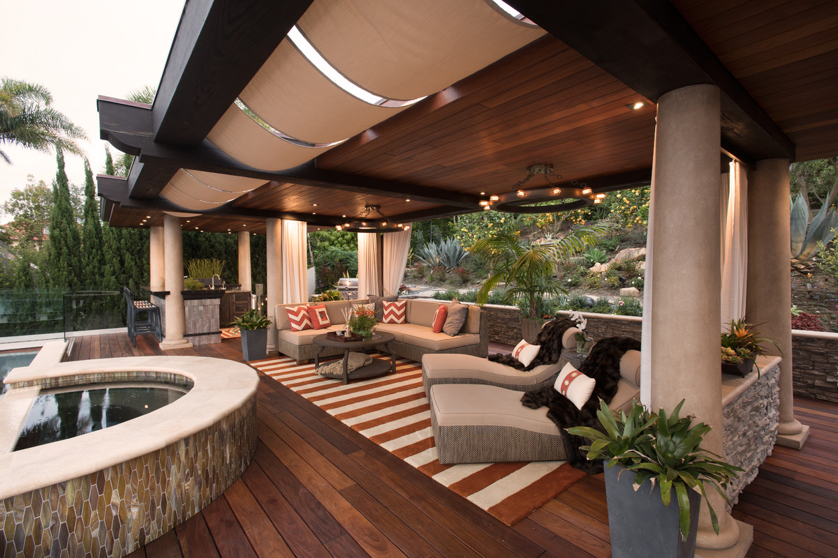 This is an example of a large transitional backyard patio in San Diego with an outdoor kitchen, decking and a gazebo/cabana.