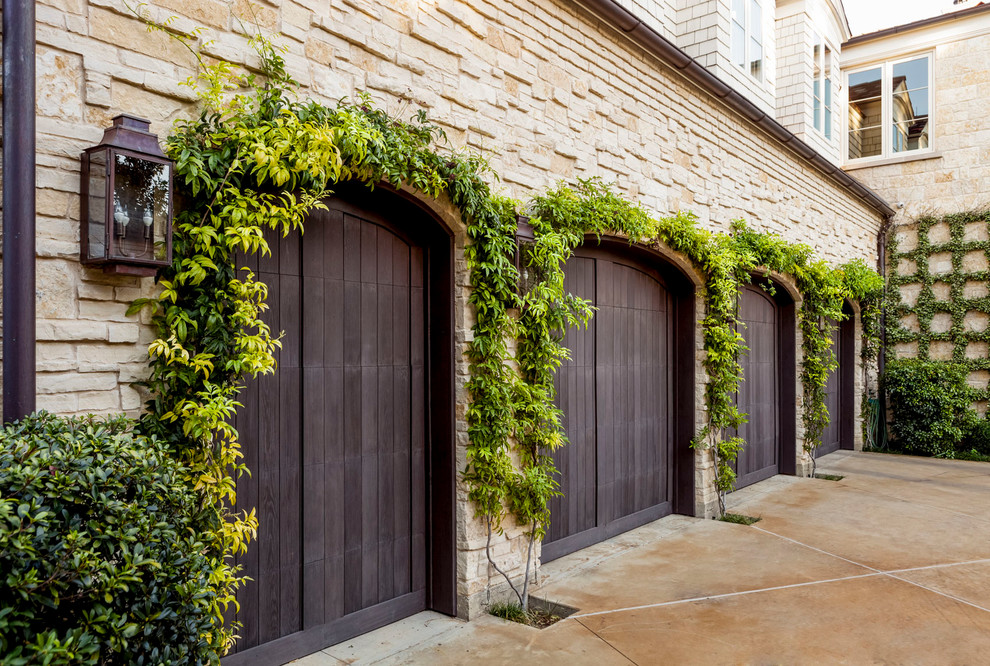 This is an example of a transitional attached four-car garage in Dallas.