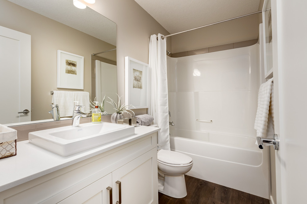 Inspiration for a small transitional 3/4 bathroom in Calgary with shaker cabinets, white cabinets, a one-piece toilet, beige tile, cement tile, beige walls, dark hardwood floors, a drop-in sink, engineered quartz benchtops, brown floor, turquoise benchtops, a single vanity and a built-in vanity.