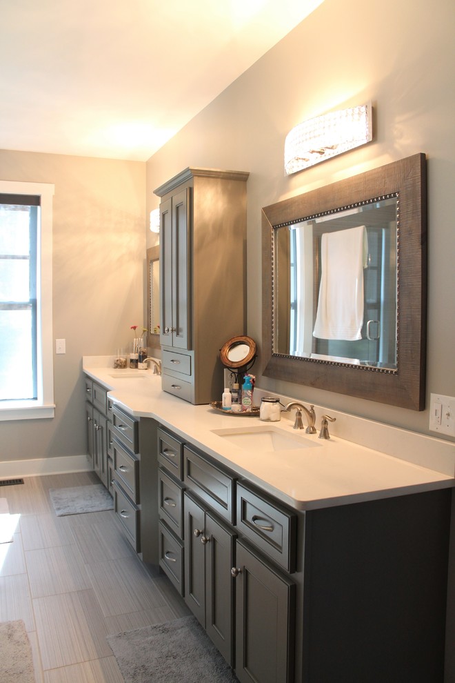 Mid-sized transitional master bathroom in Nashville with a drop-in tub, porcelain floors, an undermount sink, engineered quartz benchtops, grey floor, recessed-panel cabinets and grey cabinets.