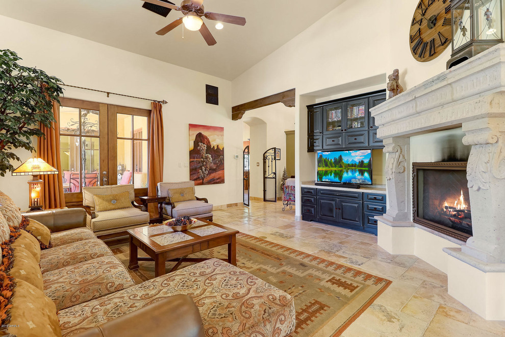 Expansive mediterranean open concept family room in Phoenix with white walls, medium hardwood floors, a two-sided fireplace and multi-coloured floor.