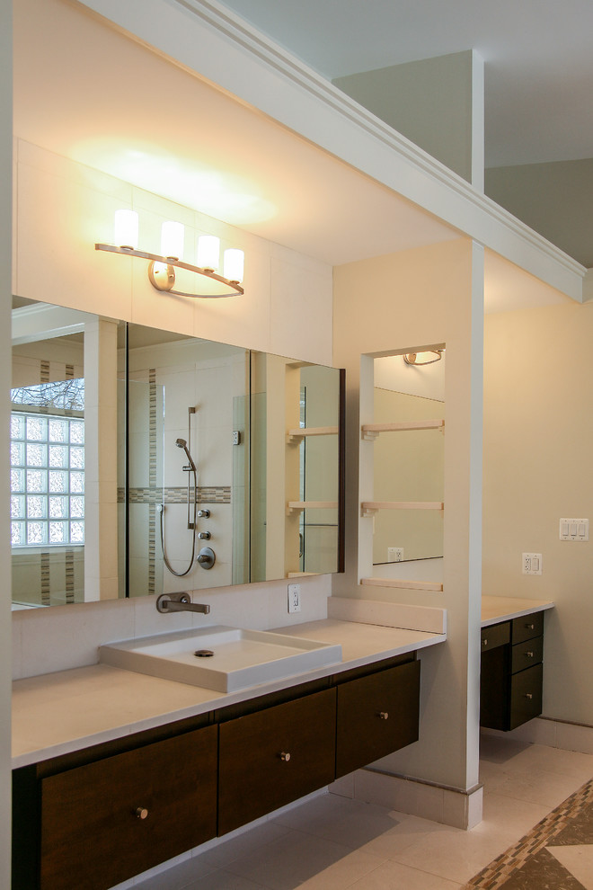 Design ideas for a mid-sized asian bathroom in DC Metro with an undermount sink, flat-panel cabinets, dark wood cabinets, limestone benchtops, a drop-in tub, a double shower, a two-piece toilet, brown tile, stone tile, white walls and limestone floors.