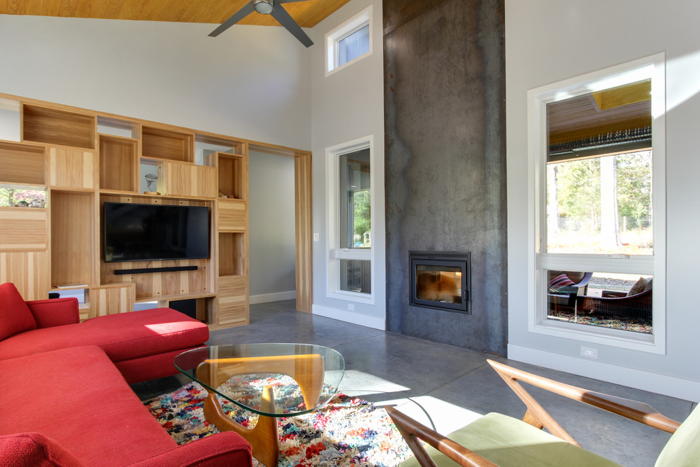 Design ideas for a mid-sized contemporary open concept living room in Raleigh with concrete floors, a two-sided fireplace and a metal fireplace surround.