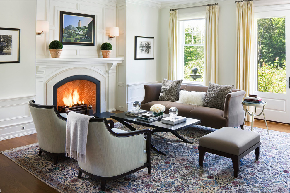 Design ideas for a traditional formal living room in New York with white walls, medium hardwood floors and a standard fireplace.