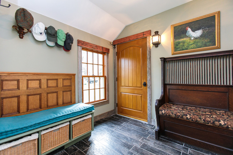 Mid-sized traditional hallway in Boston with beige walls, ceramic floors and black floor.