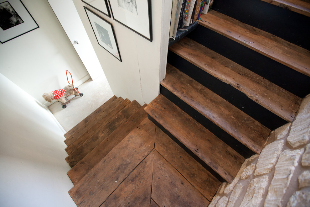 Photo of a small country wood l-shaped staircase in Gloucestershire with wood risers.