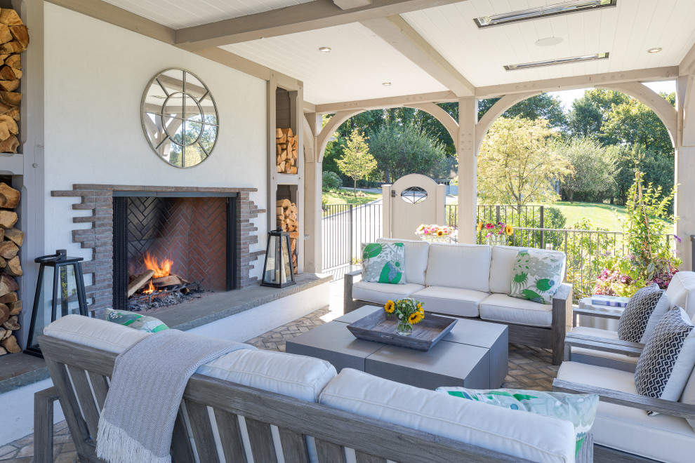 Inspiration for a french country backyard brick patio remodel in New York with a fireplace