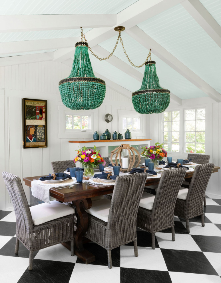 Coastal dining room in Baltimore with white walls, multi-coloured floors, exposed beams, a vaulted ceiling and tongue and groove walls.