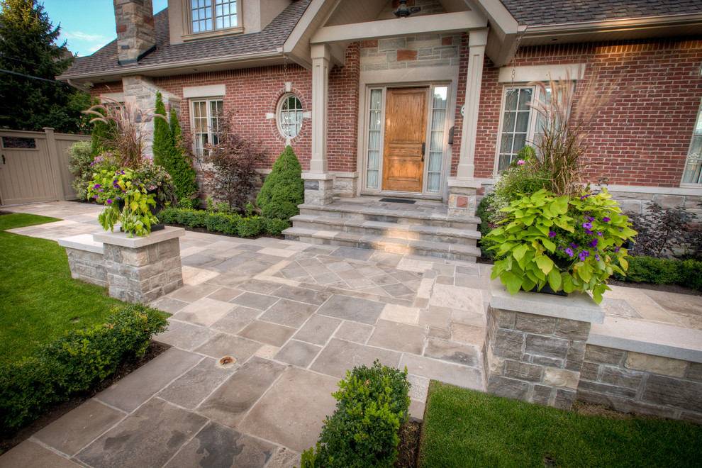 Design ideas for a large contemporary front yard garden for summer in Toronto with a garden path and natural stone pavers.