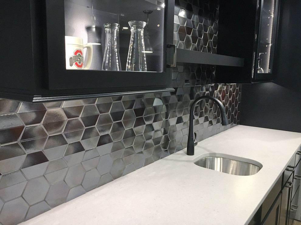 Large modern galley wet bar in Other with an undermount sink, shaker cabinets, black cabinets, quartz benchtops, grey splashback and metal splashback.