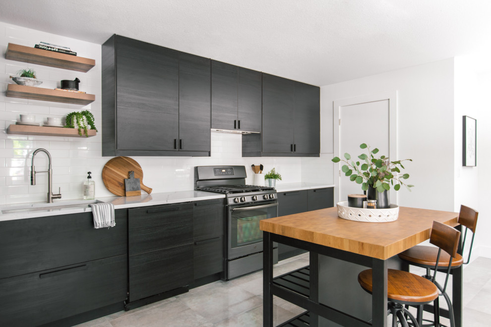 Photo of a small scandinavian l-shaped kitchen pantry in Tampa with a drop-in sink, flat-panel cabinets, black cabinets, quartz benchtops, white splashback, engineered quartz splashback, black appliances, ceramic floors, with island, grey floor and white benchtop.