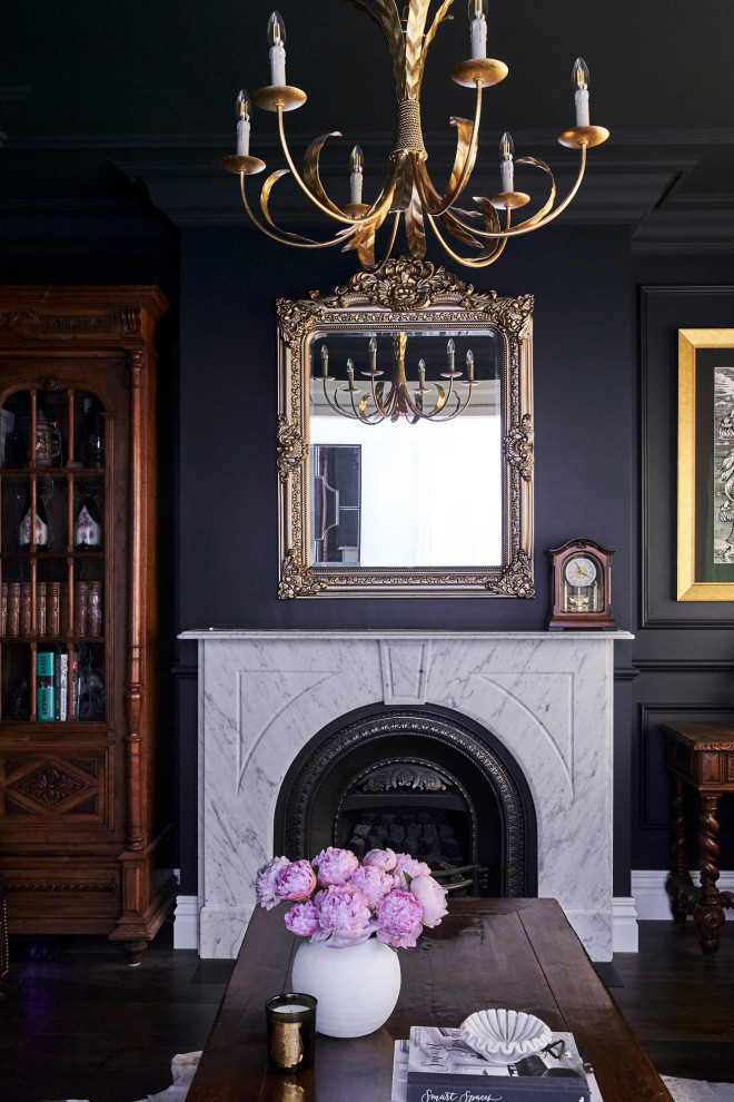 Inspiration for a traditional formal living room in Sydney with black walls, dark hardwood floors, a standard fireplace, a stone fireplace surround and brown floor.