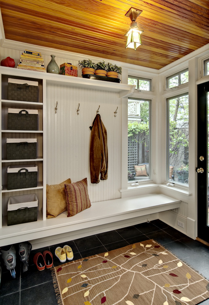 Inspiration for a traditional mudroom in Minneapolis with white walls.