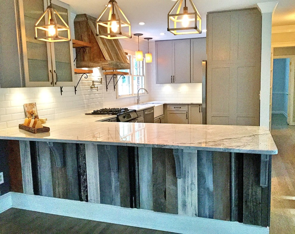 Inspiration for a mid-sized rustic u-shaped light wood floor open concept kitchen remodel in Atlanta with a farmhouse sink, shaker cabinets, gray cabinets, quartzite countertops, white backsplash, subway tile backsplash, stainless steel appliances and a peninsula