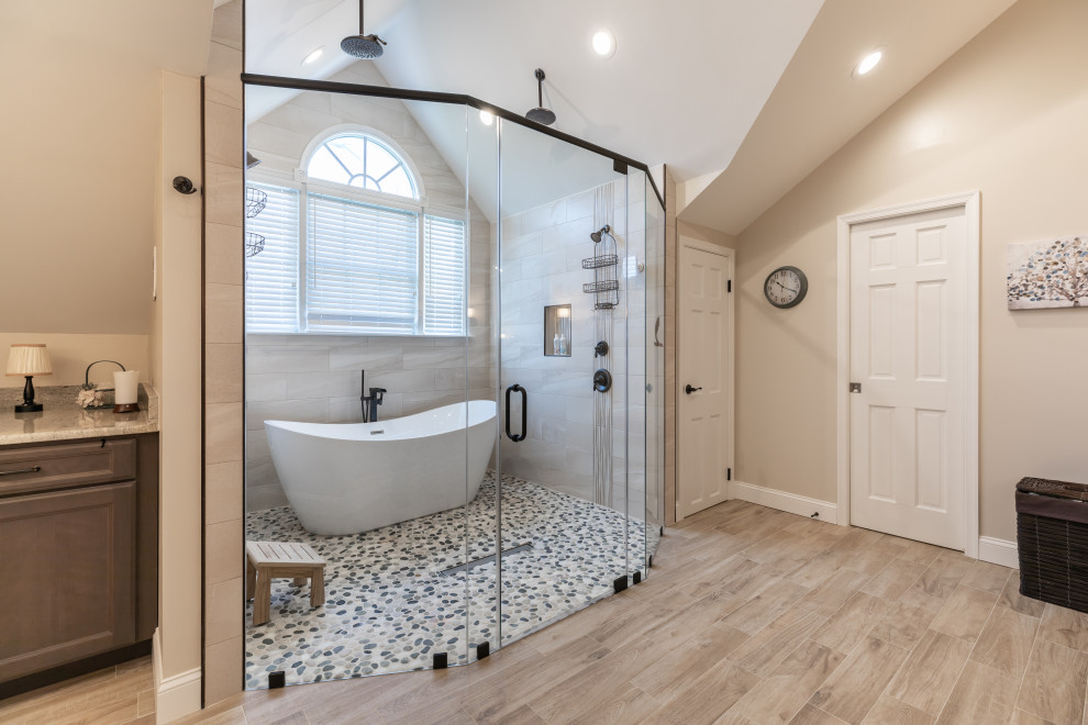 Example of a large trendy master gray tile porcelain tile, brown floor and double-sink bathroom design in DC Metro with brown cabinets, a one-piece toilet, beige walls, an undermount sink, a hinged shower door, gray countertops and a built-in vanity