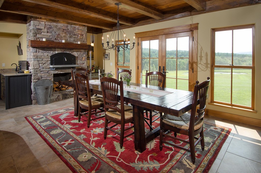Photo of a traditional dining room in Burlington with beige walls, a standard fireplace and a stone fireplace surround.