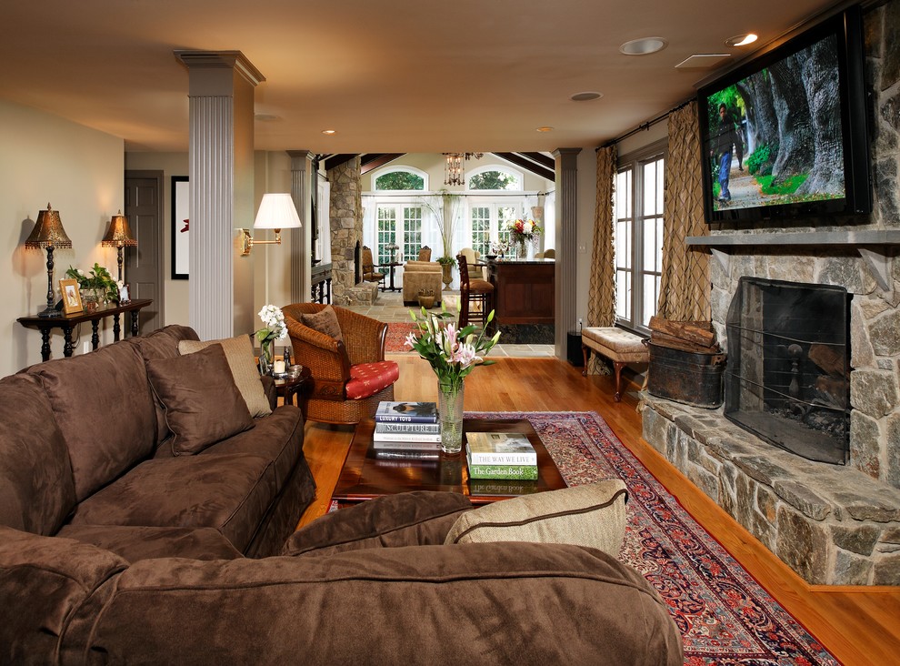 Photo of a traditional living room in DC Metro with a stone fireplace surround.