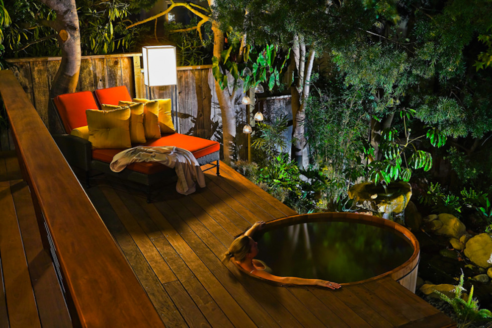 Inspiration for a small tropical backyard round pool in Santa Barbara with a hot tub and decking.