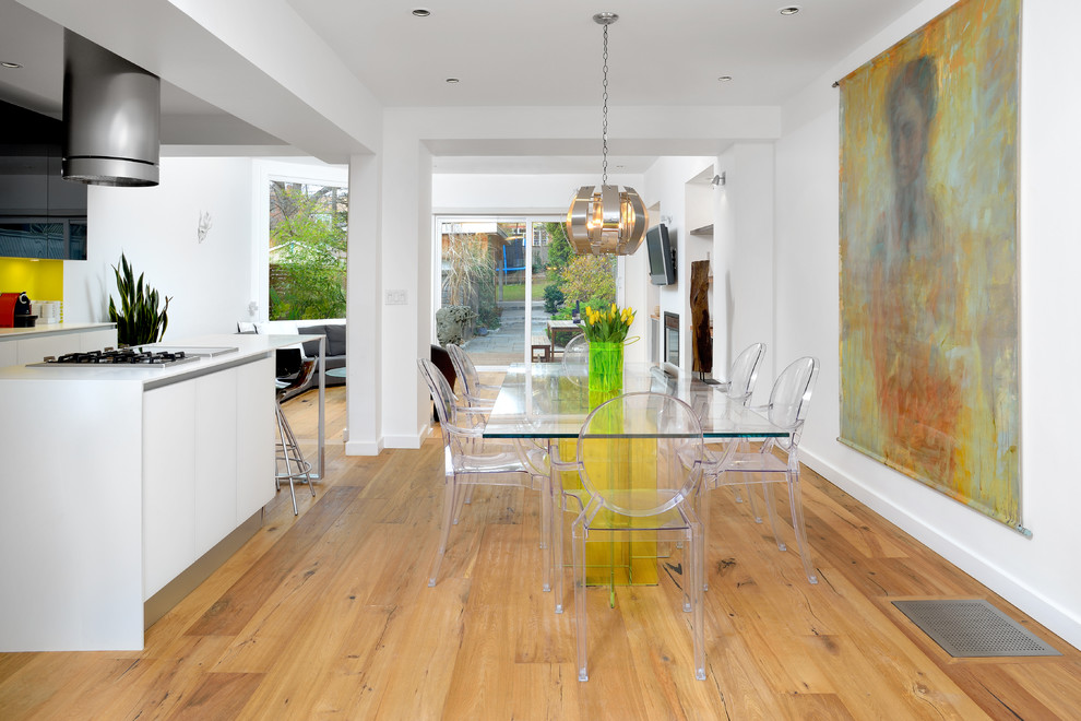Design ideas for a modern dining room in Toronto with white walls and light hardwood floors.