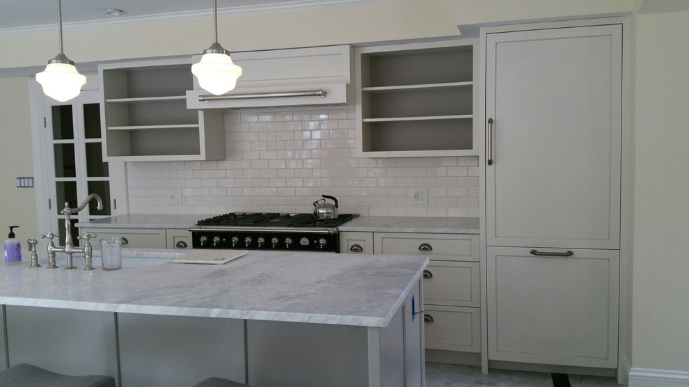 Design ideas for a mid-sized transitional single-wall eat-in kitchen in Boston with an undermount sink, shaker cabinets, white cabinets, marble benchtops, white splashback, subway tile splashback, panelled appliances, marble floors, with island and grey floor.