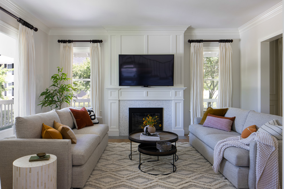 This is an example of a large traditional formal enclosed living room in San Francisco with light hardwood flooring, a standard fireplace, a tiled fireplace surround and a wall mounted tv.
