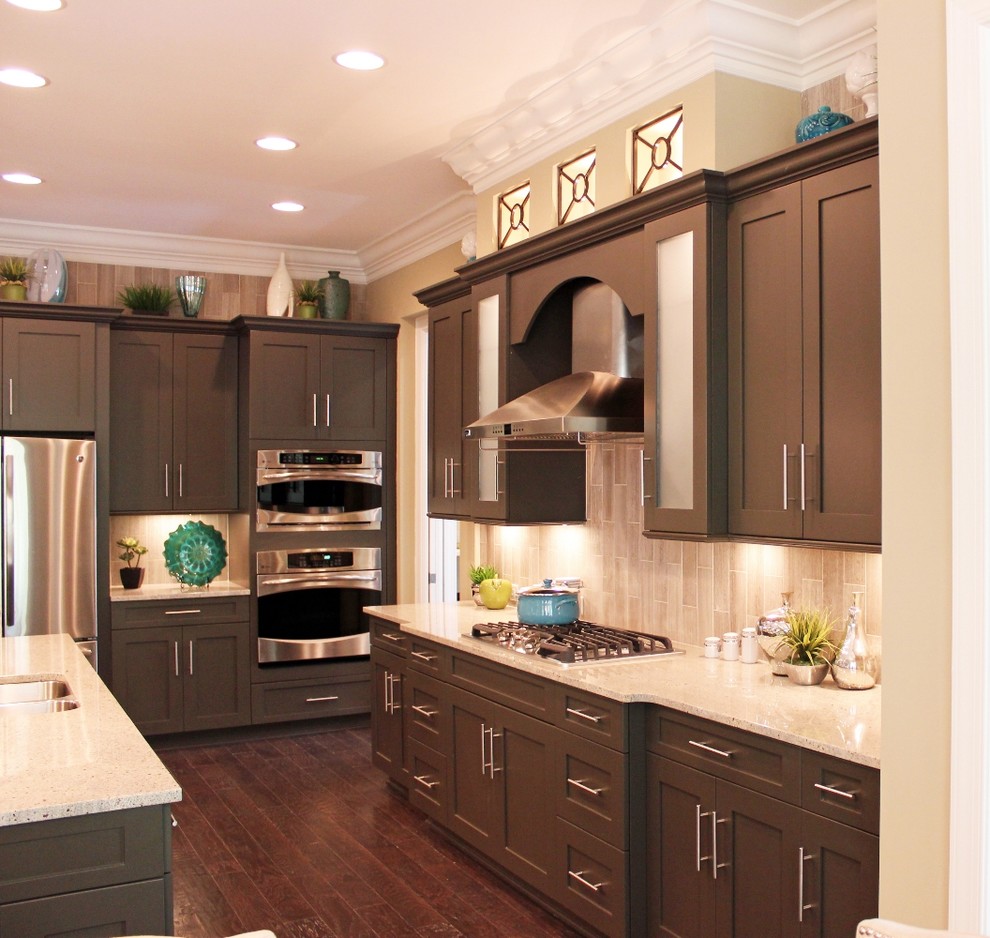 Example of a large transitional l-shaped dark wood floor eat-in kitchen design with flat-panel cabinets