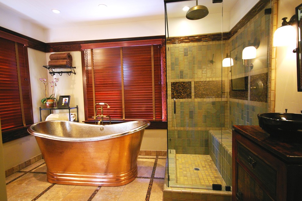 Photo of a large contemporary master bathroom in San Diego with furniture-like cabinets, dark wood cabinets, a freestanding tub, a corner shower, brown tile, green tile, ceramic tile, beige walls, ceramic floors, a vessel sink and wood benchtops.