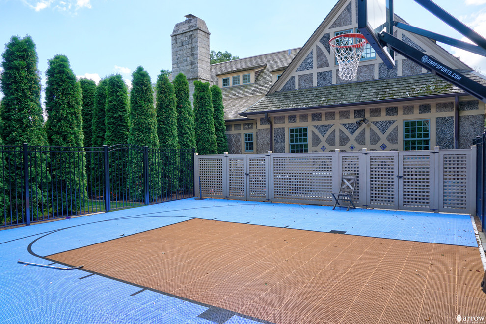 Inspiration for a mid-sized traditional backyard full sun outdoor sport court for summer in Chicago with with outdoor playset and natural stone pavers.