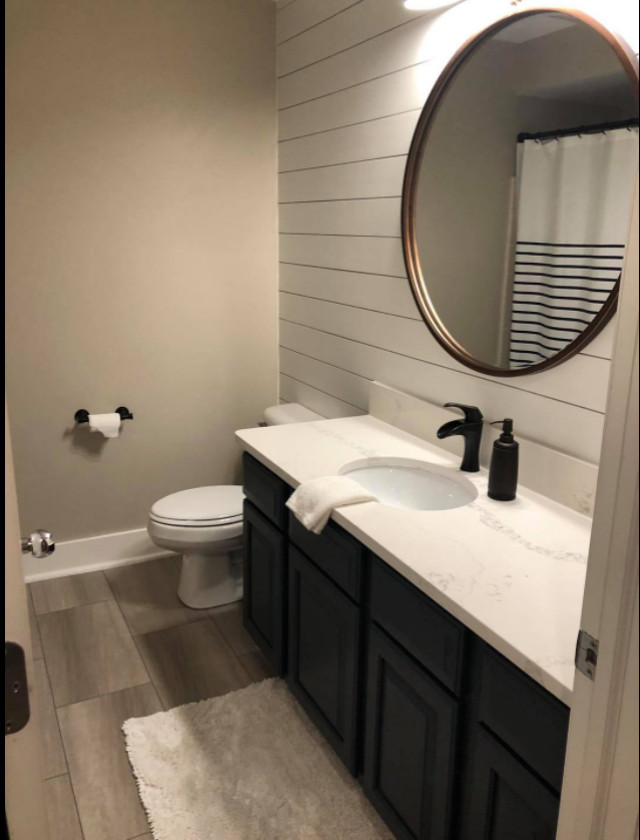 Photo of a medium sized farmhouse bathroom in Detroit with blue cabinets, beige walls, vinyl flooring, grey floors, white worktops, a single sink and tongue and groove walls.