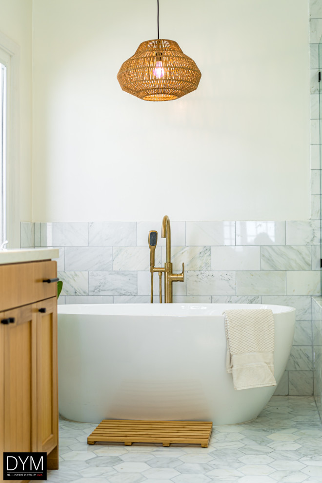 This is an example of a large midcentury master bathroom in Los Angeles with shaker cabinets, medium wood cabinets, a freestanding tub, a corner shower, a one-piece toilet, white tile, cement tile, white walls, porcelain floors, a drop-in sink, marble benchtops, grey floor, a sliding shower screen, white benchtops, a shower seat, a double vanity, a built-in vanity, wallpaper and wallpaper.