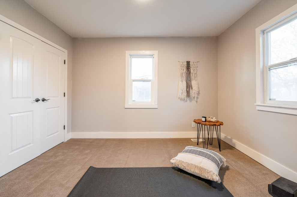 Photo of a scandinavian home gym in Salt Lake City with beige walls, carpet and beige floor.