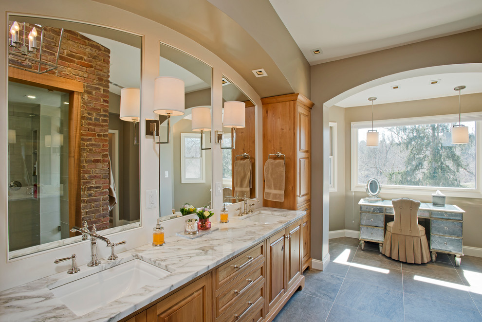 Inspiration for a large transitional master gray tile and porcelain tile porcelain tile bathroom remodel in Baltimore with an undermount sink, raised-panel cabinets, medium tone wood cabinets, marble countertops and a two-piece toilet