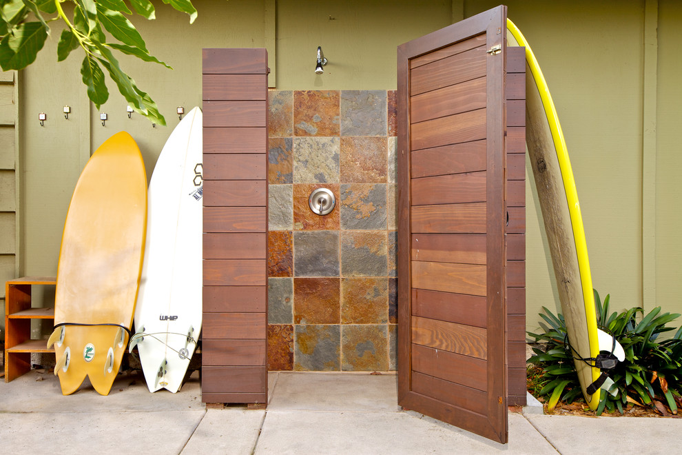 This is an example of a beach style patio in San Diego with concrete slab and an outdoor shower.