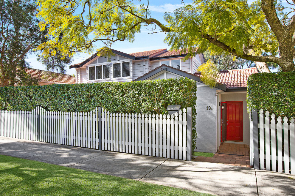 Small transitional two-storey brick grey exterior in Sydney with a gable roof.