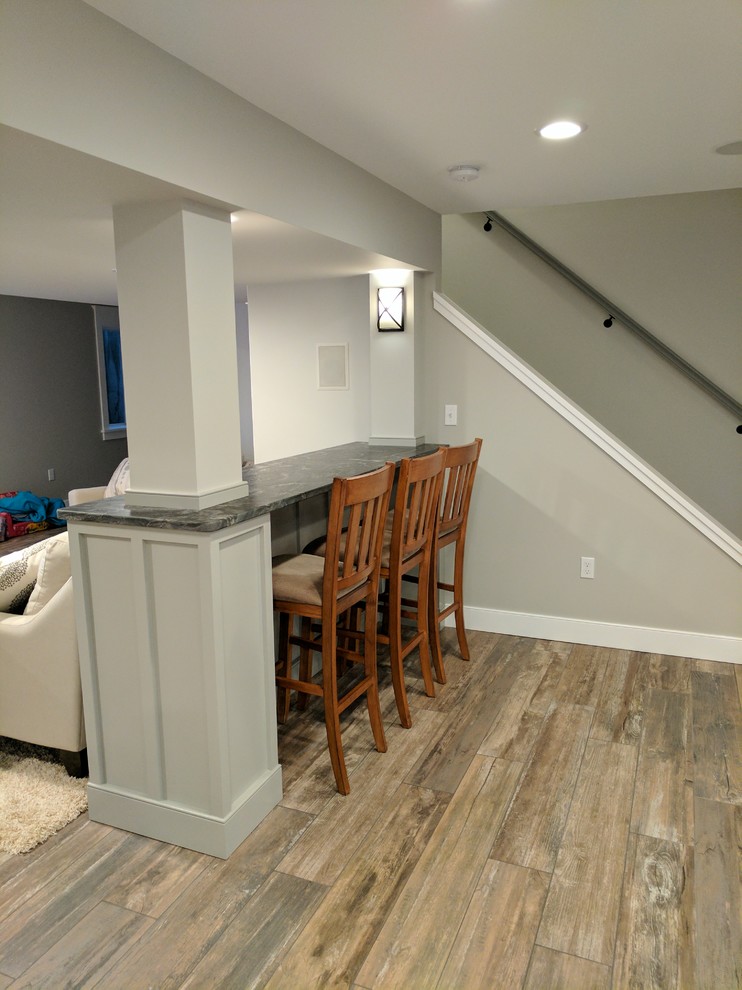 Design ideas for a mid-sized transitional look-out basement in Other with grey walls and porcelain floors.
