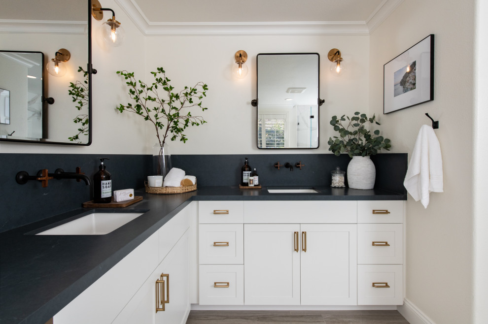 Country bathroom in Los Angeles with shaker cabinets, white cabinets, white walls, wood-look tile, an undermount sink, brown floor, black benchtops, a double vanity and a built-in vanity.