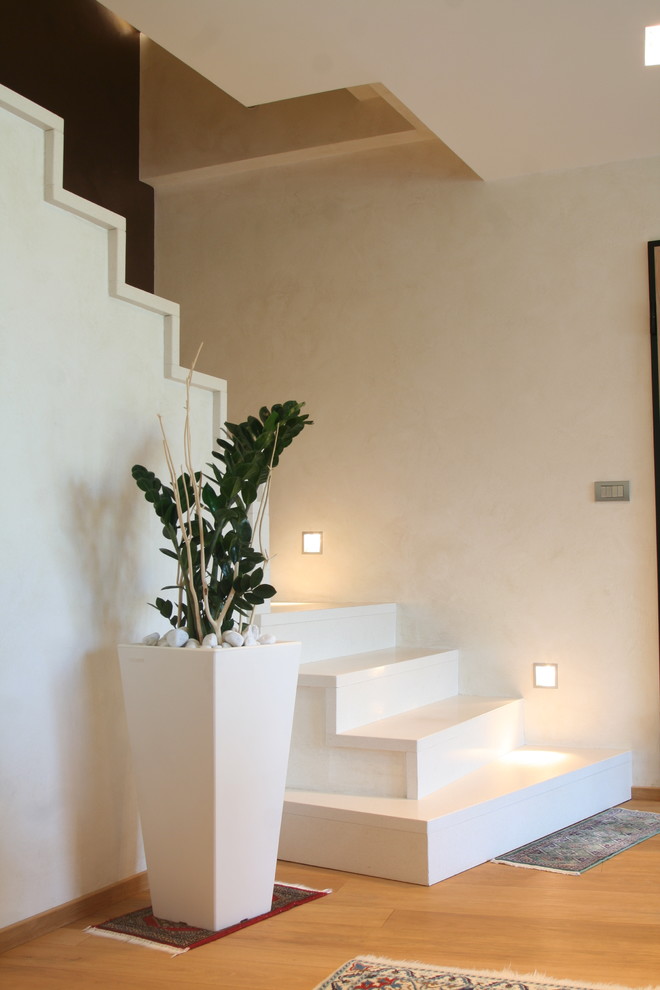 Design ideas for a large contemporary marble l-shaped staircase in Turin with marble risers.