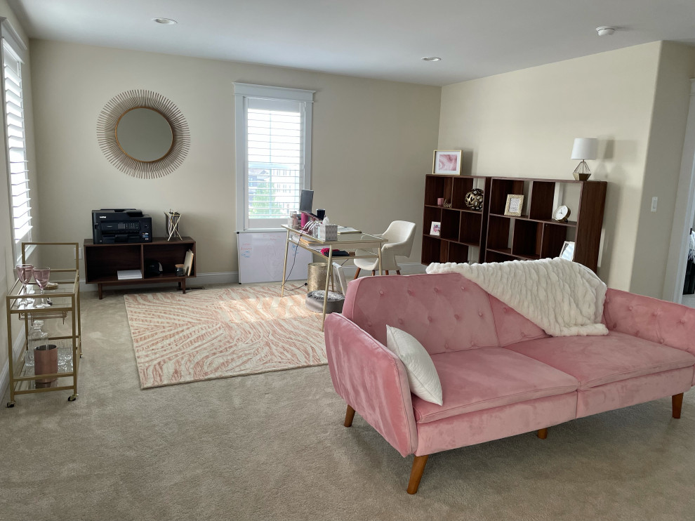 This is an example of a medium sized classic study in Denver with beige walls, carpet and a freestanding desk.