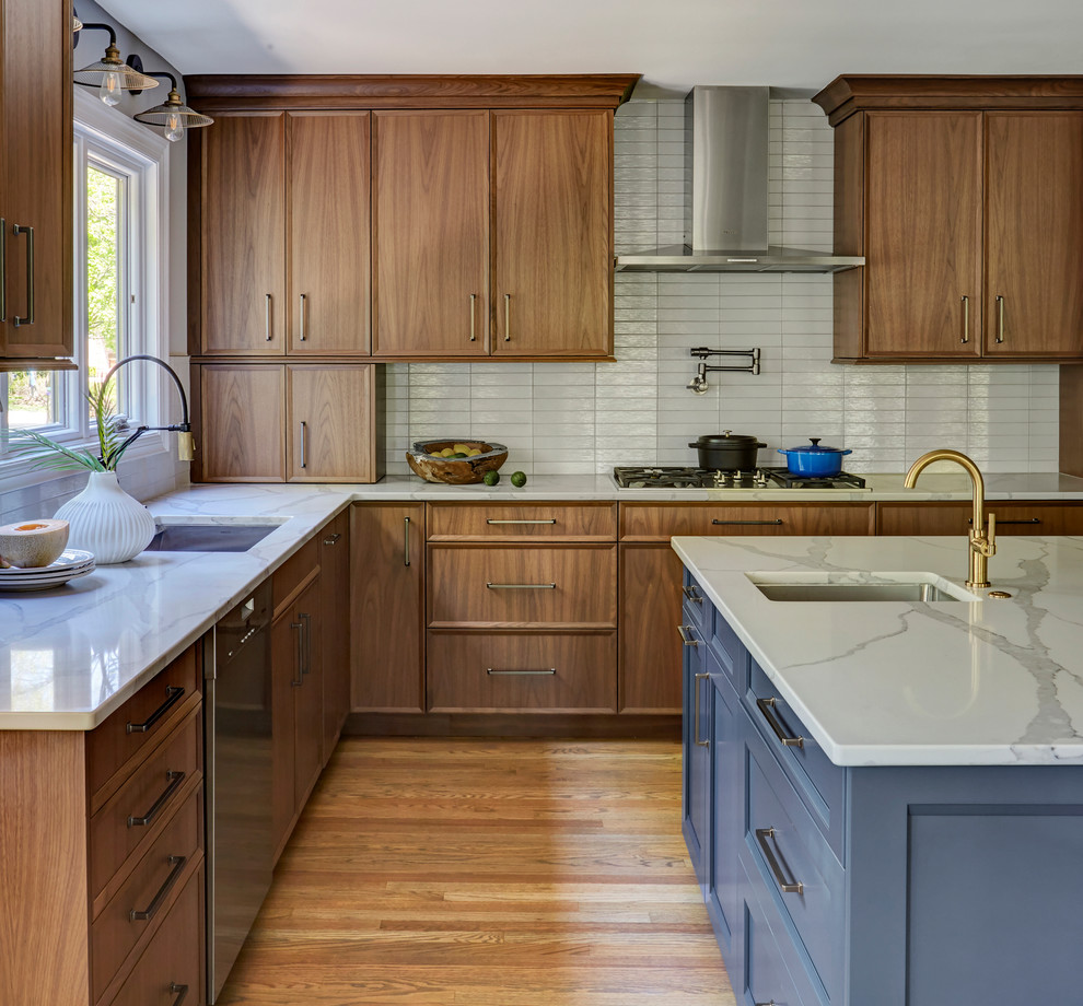 Large minimalist l-shaped medium tone wood floor and brown floor open concept kitchen photo in Chicago with an undermount sink, flat-panel cabinets, medium tone wood cabinets, quartz countertops, white backsplash, subway tile backsplash, stainless steel appliances, an island and white countertops