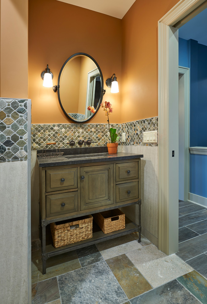 This is an example of a traditional powder room in New York with distressed cabinets, beige tile, slate floors, granite benchtops, multi-coloured floor and grey benchtops.