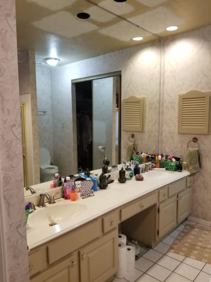 This is an example of a medium sized ensuite bathroom in Houston with shaker cabinets, white cabinets, a corner shower, a one-piece toilet, white tiles, cement tiles, white walls, ceramic flooring, a console sink, marble worktops, grey floors, an open shower, white worktops, a single sink, a built in vanity unit and a coffered ceiling.