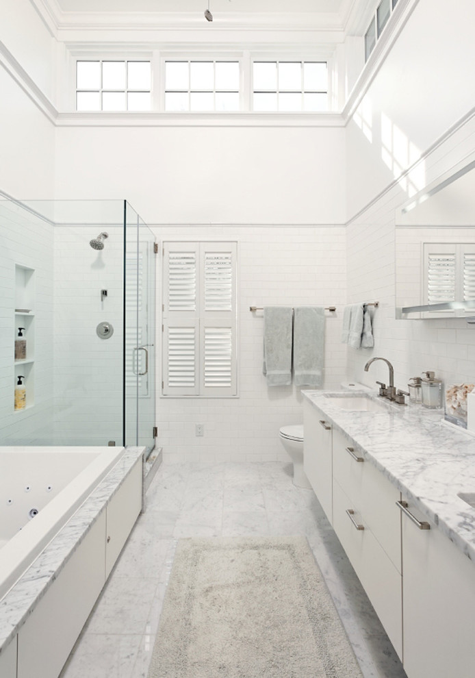 This is an example of a contemporary bathroom in DC Metro with subway tile and marble floors.