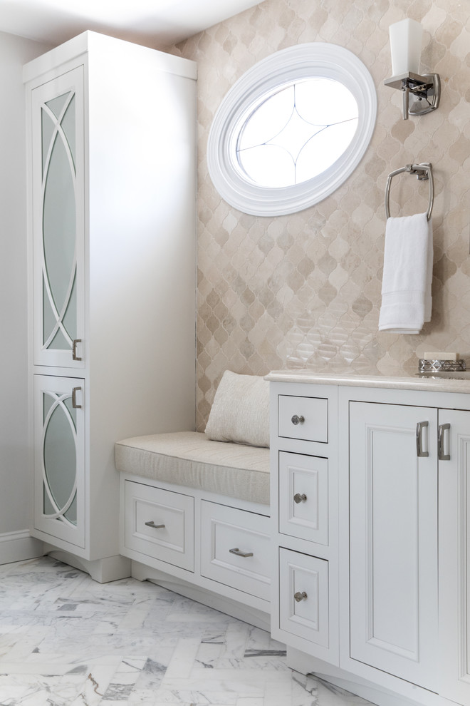 Photo of a transitional master bathroom in Boston with recessed-panel cabinets, white cabinets, a freestanding tub, a curbless shower, a one-piece toilet, beige tile, mosaic tile, white walls, marble floors, an undermount sink, engineered quartz benchtops, grey floor, a hinged shower door and beige benchtops.