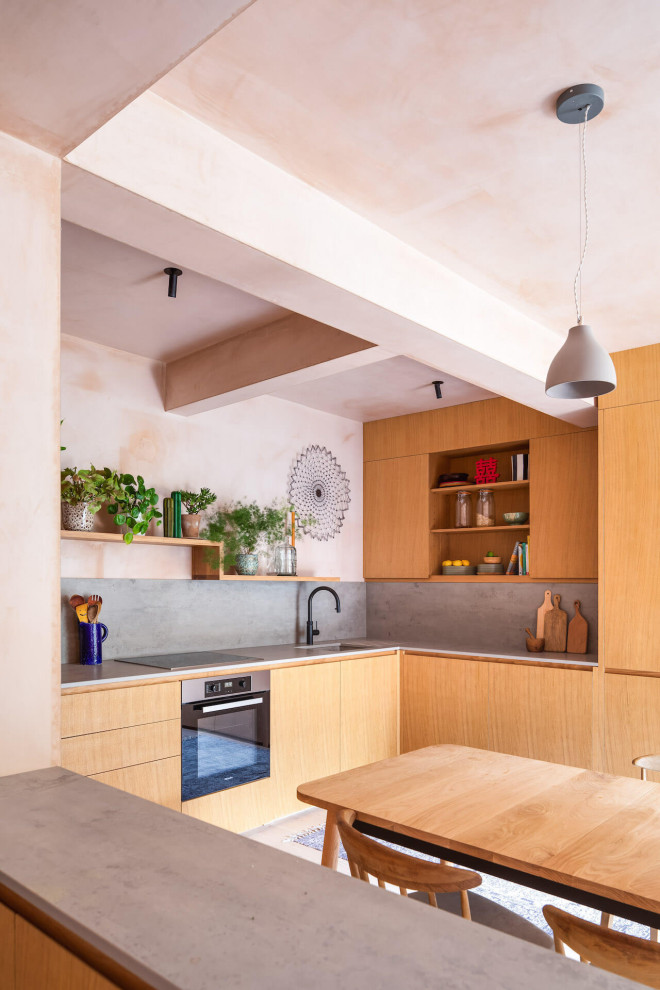 Photo of a mid-sized modern l-shaped eat-in kitchen in London.