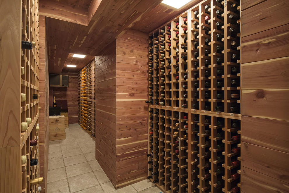 Expansive traditional wine cellar in New York with ceramic floors and storage racks.