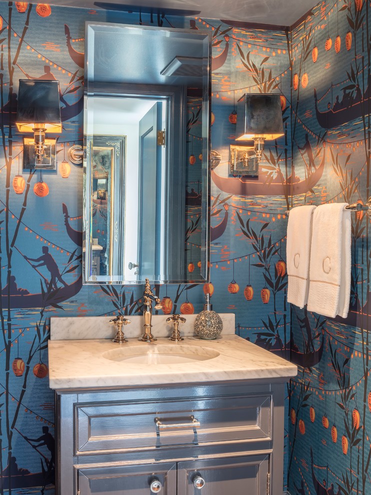 Example of a transitional powder room design in San Francisco with recessed-panel cabinets, gray cabinets, multicolored walls, an undermount sink and white countertops