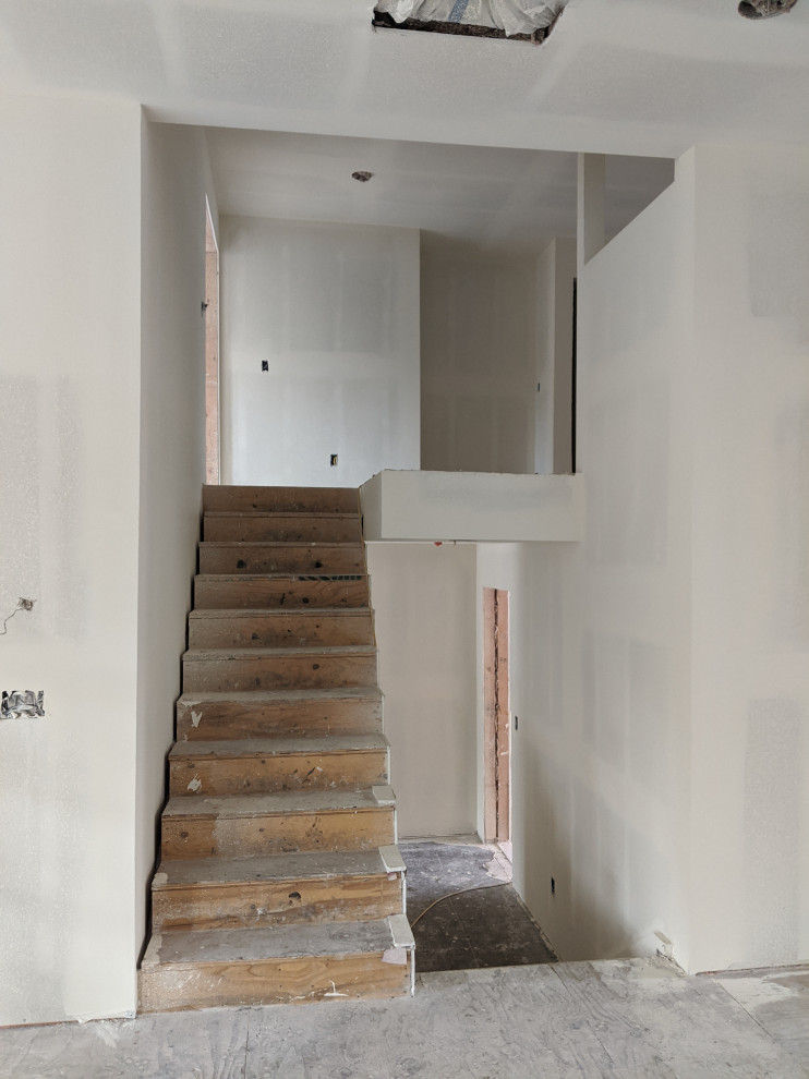 Architectural molding and railing near staircase