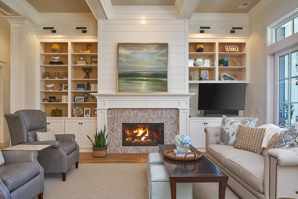 This is an example of a mid-sized transitional open concept living room in Charleston with beige walls, medium hardwood floors, a standard fireplace, a tile fireplace surround and a wall-mounted tv.