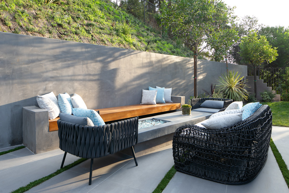 Inspiration for a contemporary backyard patio in Los Angeles with tile and no cover.