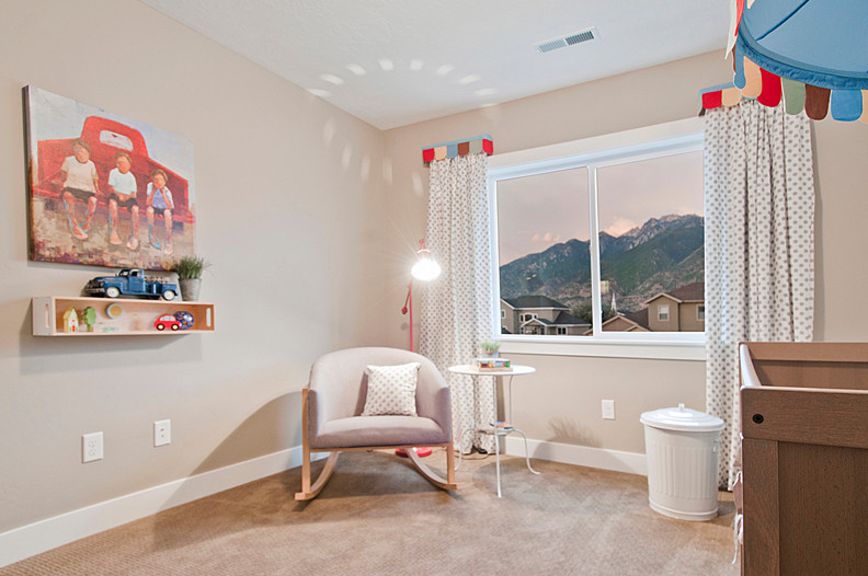 This is an example of a mid-sized contemporary kids' room for boys in Salt Lake City with beige walls and carpet.